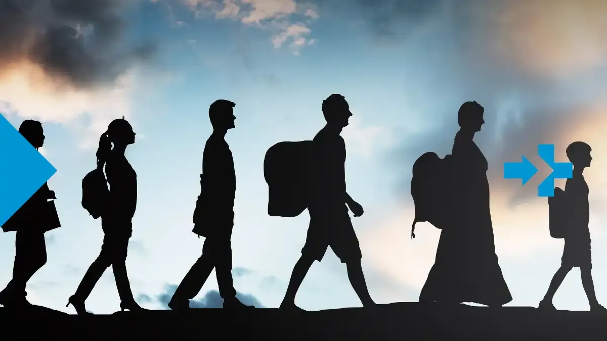 Silhouette of refugee family walking at sunset, carrying backpacks and bags.